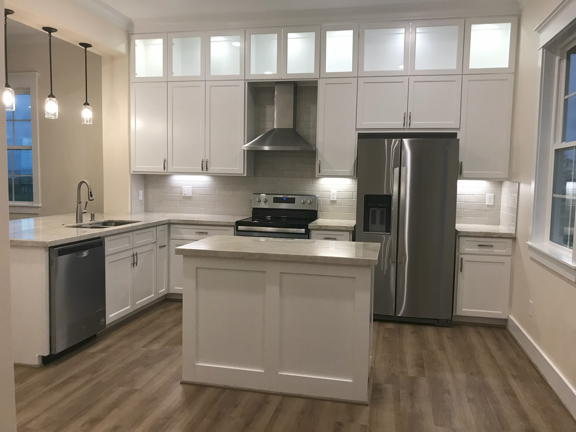 Luxury kitchen with marble countertops and ocean view.